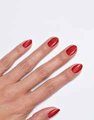 Models' hand showcasing Sally Hansen Miracle Gel Supercharged Bold Glam in XOXO Sally 460, a radiant red pearl nail colour
