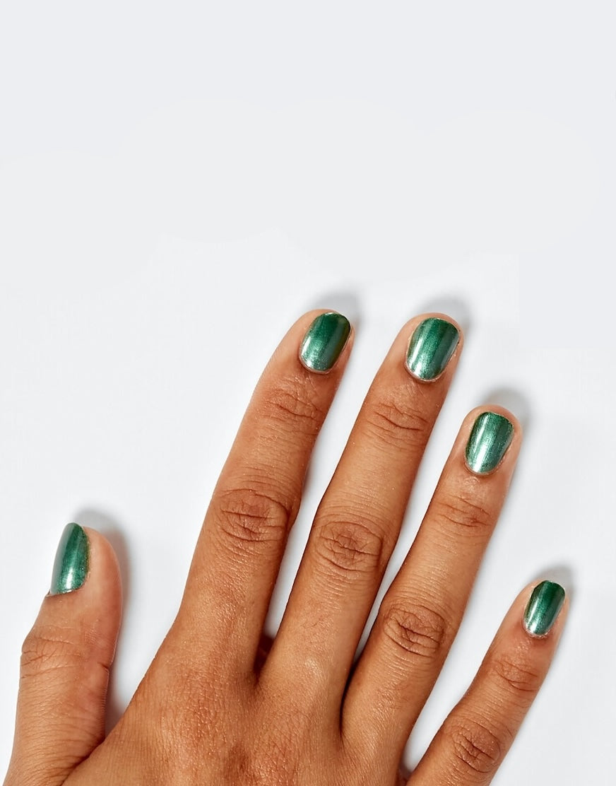 Models' hand showcasing Sally Hansen Miracle Gel Supercharged Bold Glam in Rocket Fuel 735, a fresh green pearl nail colour