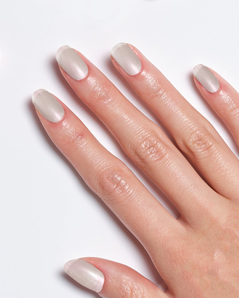 Model's hand showcasing Miracle Gel Supercharged Pinks in Boss Babe with a soft, light pink finish.