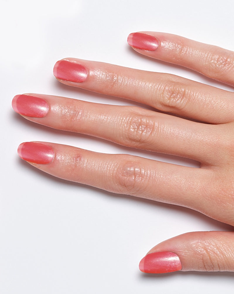 Model's hand showcasing Miracle Gel Supercharged Pinks nail polish in a soft pink shade.
