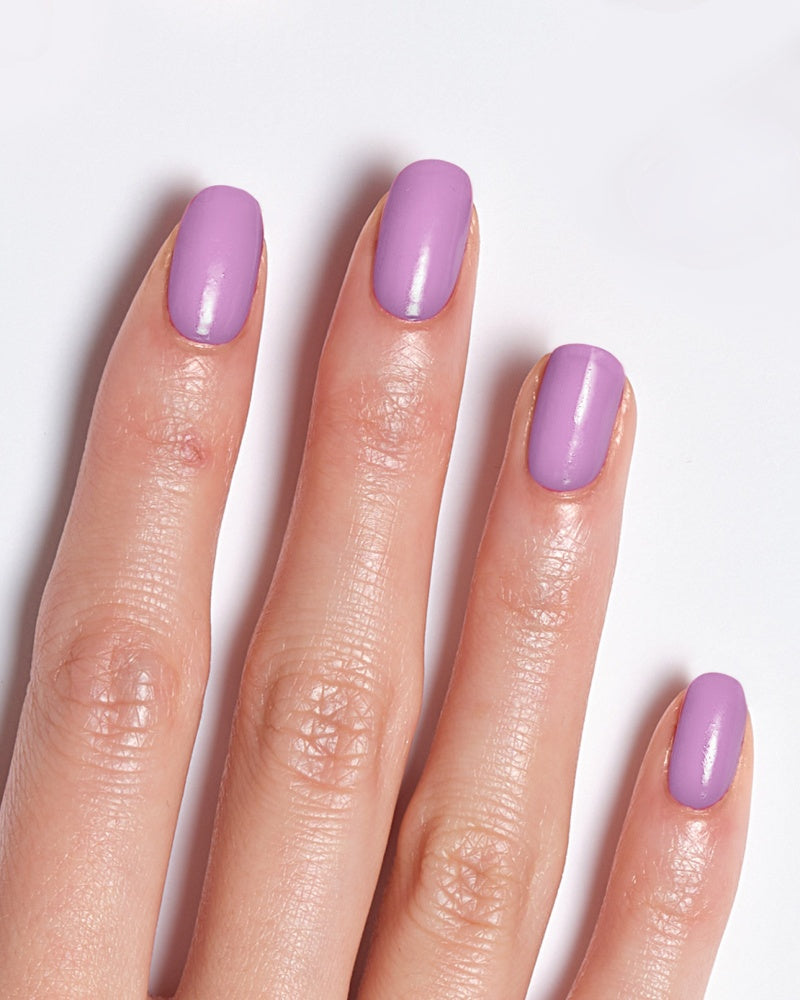 Model's hand showing nails painted in a vibrant purple shade, representing Miracle Gel Supercharged Pinks - Unstop-purple.